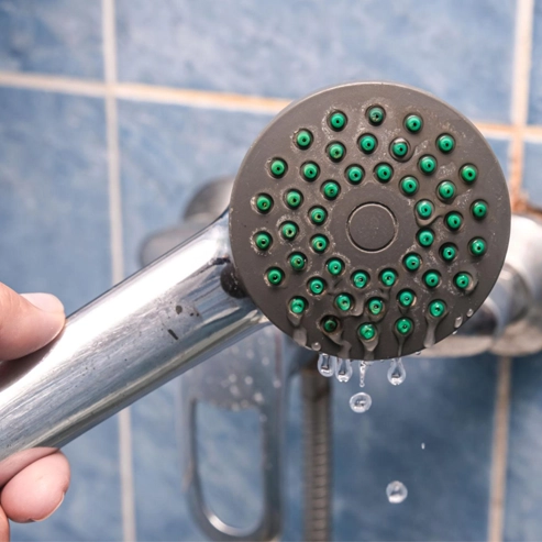 Mineral buildup inside shower head reducing water pressure performance